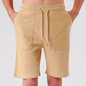 กางเกงขาสั้นกีฬาฝึกซ้อมวิ่ง คุณภาพสูง ผ้าฝ้าย 100% สำหรับทุกเพศ สวมใส่สบาย ไม่ยับ แห้งเร็ว ระบายอากาศดี มีกระเป๋า บริการ OEM สำหรับผู้ชาย - Product Image 1