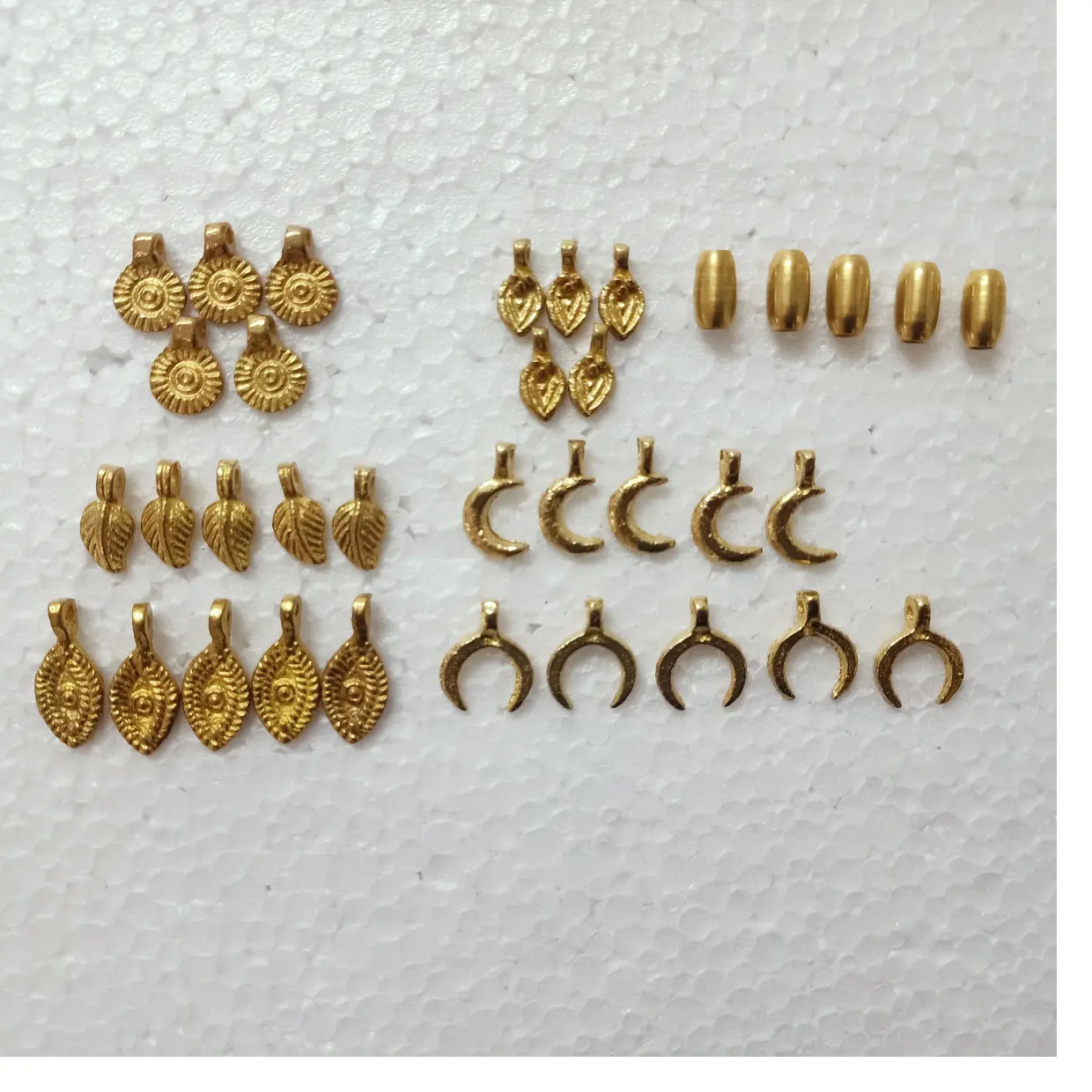custom made brass charms and brass pendants in an assortment of designs ideal for native jewelry designers for resale