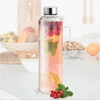 Bouteille d'eau en verre borosilicate transparent en gros avec couvercle en métal, réutilisable, pour voyage, réfrigérateur, boissons, jus, logo personnalisable