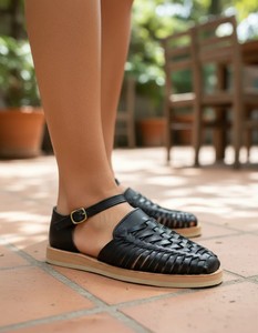 Black woven leather loafers with closed toe, buckle strap and flat sole, casual style. - Product Image 1