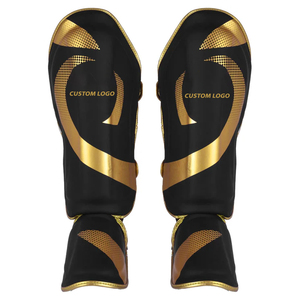 Protector de Espinilla de Cuero Negro Dorado con Cierre de Velcro para Entrenamiento de MMA y Muay Thai - Protección Completa para la Pierna y el Empeine, Absorción de Impactos - Product Image 1