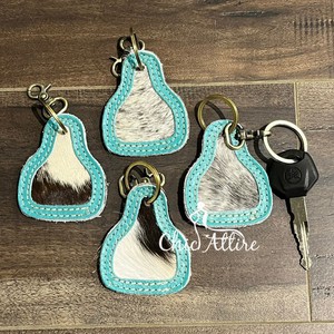 Nouveaux porte-clés en cuir de vachette à cheveux de luxe personnalisés Porte-clés de créateur élégant Porte-clés en cuir véritable de forme unique pour unisexe - Product Image 1