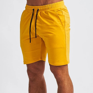 กางเกงขาสั้นออกกำลังกายในยิมของผู้ชายผ้าฝ้าย100% สไตล์สตรีทลำลองสีพื้นใหม่เป็นมิตรกับสิ่งแวดล้อม - Product Image 1