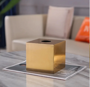 Une boîte à mouchoirs carrée élégante et minimaliste dans une finition en or poli, offrant une élégance discrète et une sensation contemporaine. - Product Image 1