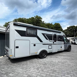 Autocaravana compacta blanca con detalles negros y diseño de puerta lateral - Product Image 1