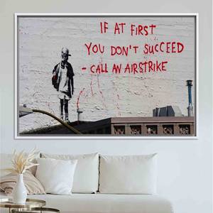 Lienzo Impreso 'Call an Airstrike' de Banksy - Impresión de Arte Callejero Moderno, Lienzo Enmarcado en Blanco - Product Image 1