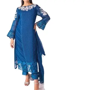 Pakistani women formal wear for occasions like Eid and wedding , blue chiffon dress with white embroidery, and patch work.