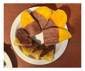 Dégustez l'harmonie des fruits secs d'ananas avec du chocolat noir et de la mangue enrobée de vanille et de mélanges de chocolat blanc. - Product Image 1
