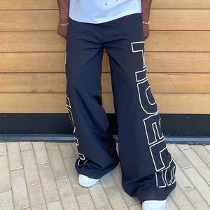 <b>Spray</b> OEM Screen Printing Logo Sportswear Windbreaker Pants Custom Elastic Waist Men Wide Leg Baggy Nylon Track Pants - Product Image 6