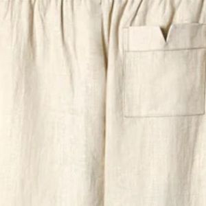 Sand linen <b>pants</b> with an elastic waist, button-fly, zippered side pocket, and sewn pleats, offering a breezy, relaxed fit - Product Image 6