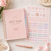 Agenda scolaire LABON personnalisé 2027 2028 avec nœud rose, format A5 B5, spirale, couverture rigide, onglets, autocollants, organisateur mensuel et hebdomadaire, designs OEM