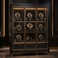 Luxuriöse Schwarz-Gold Schmuck-Vitrine Gebogene Glasvitrine Freistehende Verkaufsvitrine mit LED-Warmlicht