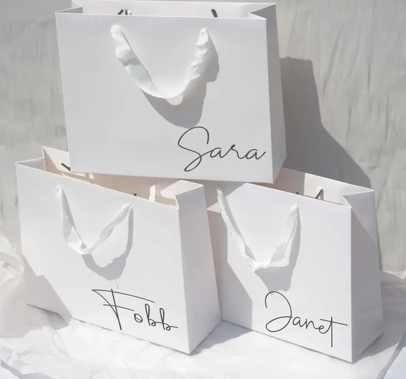 Bolsa de compras de papel de regalo de embalaje de boutique de zapatos con logotipo personalizado de marca de lujo para ropa