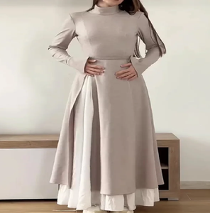 Minimalist taupe high-neck abaya with a layered <b>white</b> inner <b>skirt</b>. Available at wholesale prices. - Product Image 1