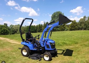 Tractor de ruedas Yuki de 24HP azul con cargador frontal y accesorio de cortadora - Product Image 3