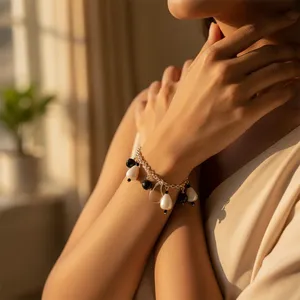 "Glamorous Gold-Plated Charm Bracelet with White & Black <b>Beads</b>" - Product Image 1