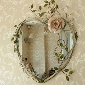 Intricately carved <b>vintage</b> gold <b>mirror</b> with a unique decorative shape and ornate scrollwork. Available at wholesale prices. - Product Image 2