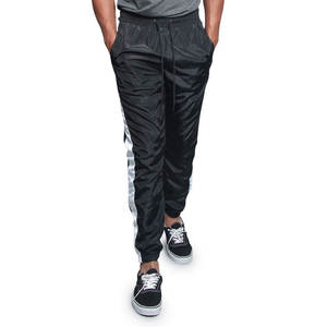 Venta al por mayor Windbreaker Jogger Pants Men Nylon Track Pants Quick Dry Professional Design Windproof Winter Trouser tracksuits - Product Image 3