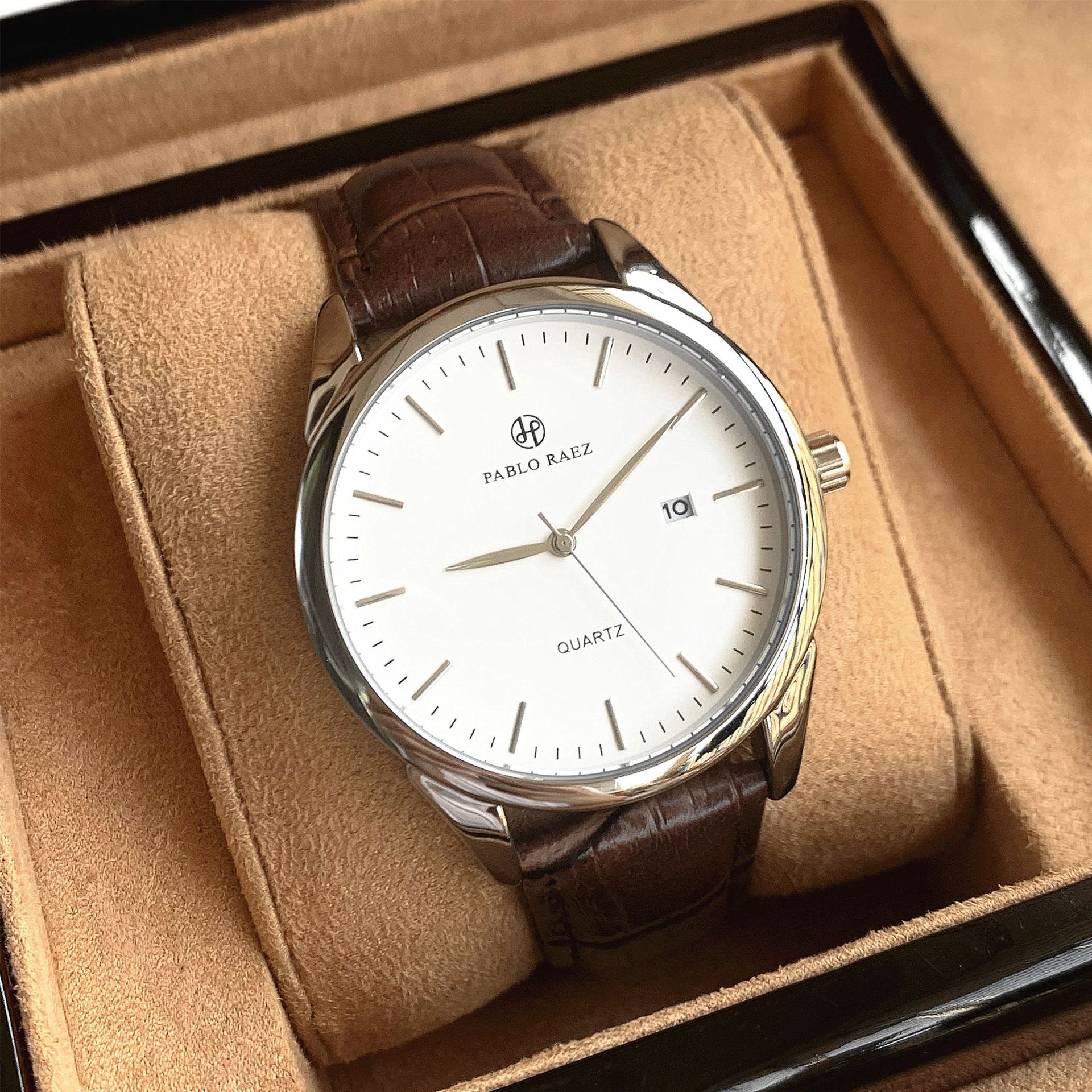 Silver shell, brown belt, white dial