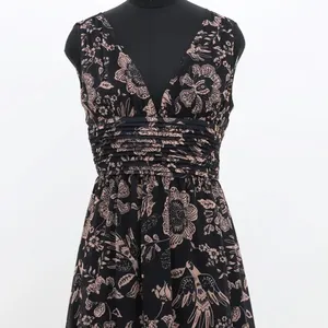 Black colored gothic Dress with plunge neckline and tiered hemline with floral prints manufactured in India
