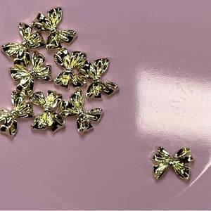 10 Pezzi Eleganti Decorazioni per Unghie a Fiocco Dorato Stile 02 Gioielli 3D per Unghie con Strass in ABS Plastica Metallo Cristallo - per Nail Art Confezione Regalo - Product Image 1