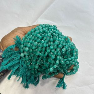 Monalisa ลูกปัดแก้วทรงวงรีสีฟ้าธรรมชาติขนาด7/9มม. พลอยสีเขียวหนึ่งเส้น12นิ้ว - Product Image 1