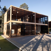 Maison de bureau préfabriquée modulaire de luxe à deux étages avec mur en verre et terrasse