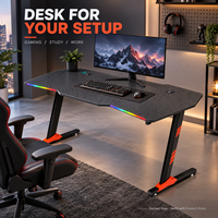 Bureau de jeu avec plateau noir sculpté et repose-pieds orange, surface en panneau E0 de 18 mm, fabriqué en Chine
