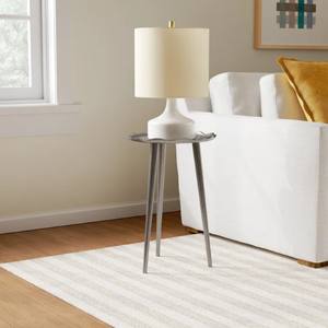 metal side table <b>possibly</b> made <b>of</b> aluminum similar lightweight metal with textured slightly uneven surface features a round - Product Image 1