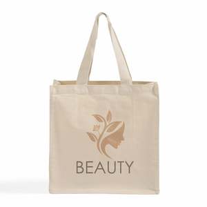 กระเป๋าผ้าแคนวาสหูหิ้วผ้าฝ้ายพิมพ์โลโก้สีพื้นแบบกำหนดเอง ขนาด 15x15x7 นิ้ว - Product Image 1