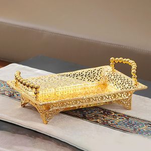 Plateau de service rectangulaire en or orné avec un design de découpe complexe et des poignées perlées, parfait pour un service et une décoration élégants - Product Image 1