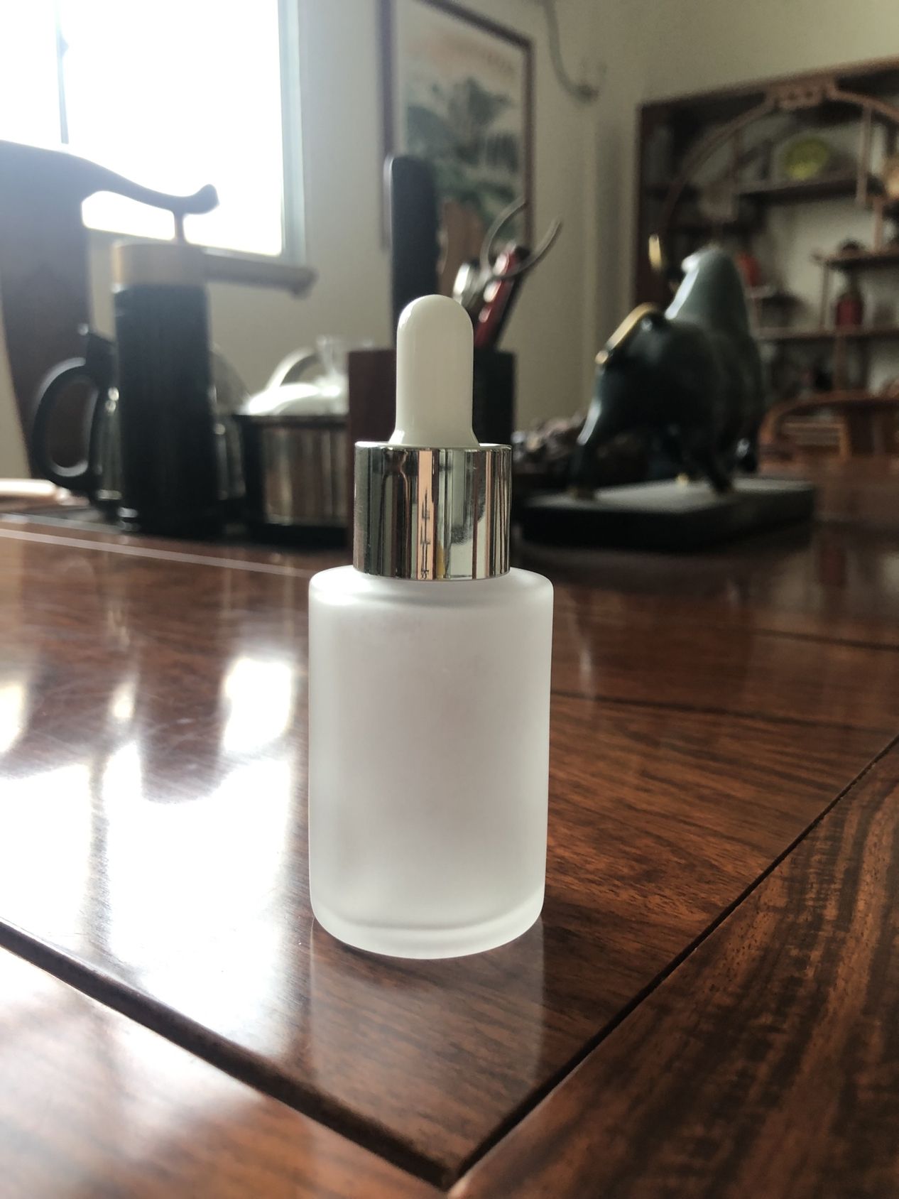 Shiny silver dropper bottle
