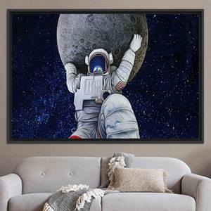 Obra de arte en lienzo Stellar Space: decoración moderna con estampado de astronauta y luna, lienzo con marco negro - Product Image 1