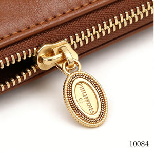 Fournisseur de quincaillerie pour sacs en cuir de haute qualité, tirette métallique ronde et ovale personnalisée avec logo gravé et embossé, avec <span class=keywords><strong>curseur</strong></span> - Product Image 3