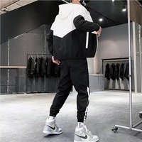 Ensemble survêtement deux pièces en polyester avec veste coupe-vent zippée en nylon et pantalon de jogging patchwork, collection hiver 2026
