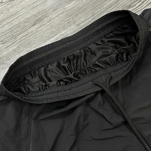 Pantalon de survêtement unisexe en nylon avec logo personnalisé, rayures incurvées, coupe ample, coupe-vent tendance, pantalon de survêtement à jambes larges avec cordon de serrage assorti - Product Image 2