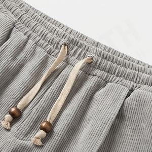 Pantalons en velours côtelé de couleur personnalisée avec cordon de serrage en bois verni, plis cousus, poche zippée dissimulée, vente en gros - Product Image 4