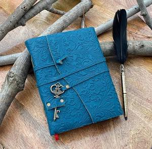 This is a handcrafted embossed leather diary designed in a stunning teal blue color The cover features an elegant floral - Product Image 1