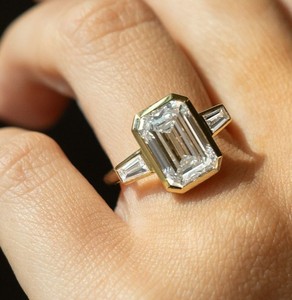 7x10 mm <b>emerald</b> cut moissanite bezel three stone <b>ring</b> with tapered baguette side stones yellow gold plated jewelry - Product Image 2