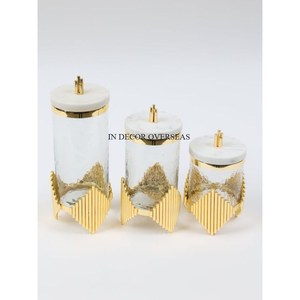 Hot Selling Unique Texture Clear <b>Glass</b> <b>Food</b> <b>Storage</b> Canister With Gold Plated Designer Metal Base And White Marble Top Lid - Product Image 1