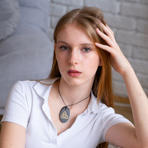 Colgante ovalado pulido de Shungite con serigrafía Triquerta 1.3*2 pulgadas (34*50 mm) - Product Image 4