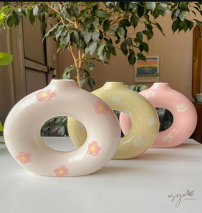 Conjunto de tres jarrones de cerámica en forma de rosquilla de color pastel con encantadores detalles florales, disponibles a precios de mayorista. - Product Image 1