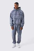 Ensemble de survêtement streetwear personnalisé délavé à l'acide, comprenant un sweat à capuche zippé et un pantalon de survêtement évasé avec patchs effet vieilli