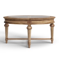 Table basse contemporaine d'aspect antique en bois de manguier massif avec plateau en verre ovale et pieds sculptés, fabriquée en Inde