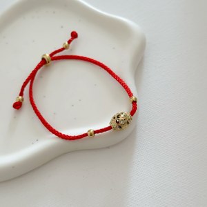 Adjustable Bohemian Red Rope <b>Bracelet</b> with Hollow Filigree Gold Bead Stainless Steel Accents and <b>Charm</b> - Product Image 1