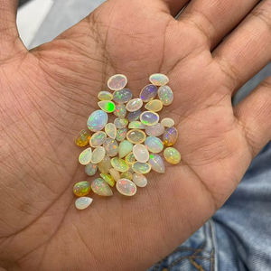 โอปอลสีขาวธรรมชาติจากเอธิโอเปีย ทรงหลังเบี้ย หลายสีรุ้ง เรียบเนียน สำหรับทำเครื่องประดับ - Product Image 1