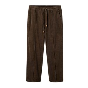 Brown Corduroy Pants Featuring Varnished Wood <strong>Stopper</strong> <strong>Drawstrings</strong>, Sewn Pleats, and a Concealed Zippered Pocket