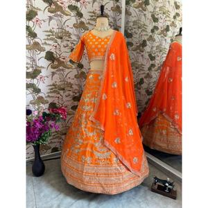 Resplandor en cada giro, esta vibrante lehenga naranja con intrincados bordados plateados es pura elegancia festiva. - Product Image 1