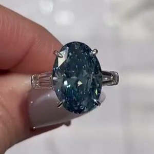 Anillo de Diamantes Azules de Laboratorio con Certificación IGI, 8.50ctw, Corte Ovalado, Tres Piedras con Laterales Baguette, Corte Catedral, VVSVS, Efecto Ombre - Product Image 1