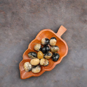 Piedra natural premium de raíz de palma con ojos – Cristal de madera fósil exótica de Indonesia con patrones oculares únicos (2–3 cm) - Product Image 5